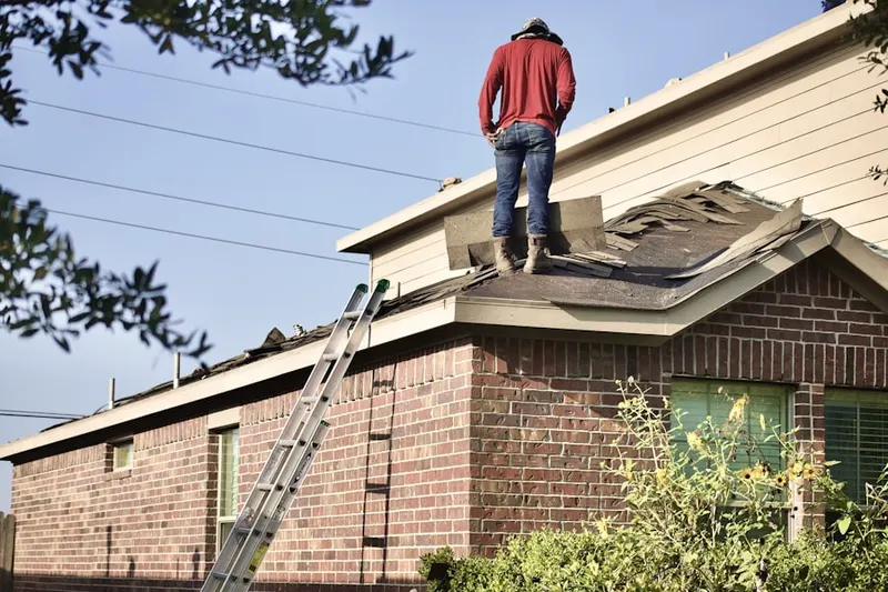 Professional roofer working on a residential roof in Mohican Hills
